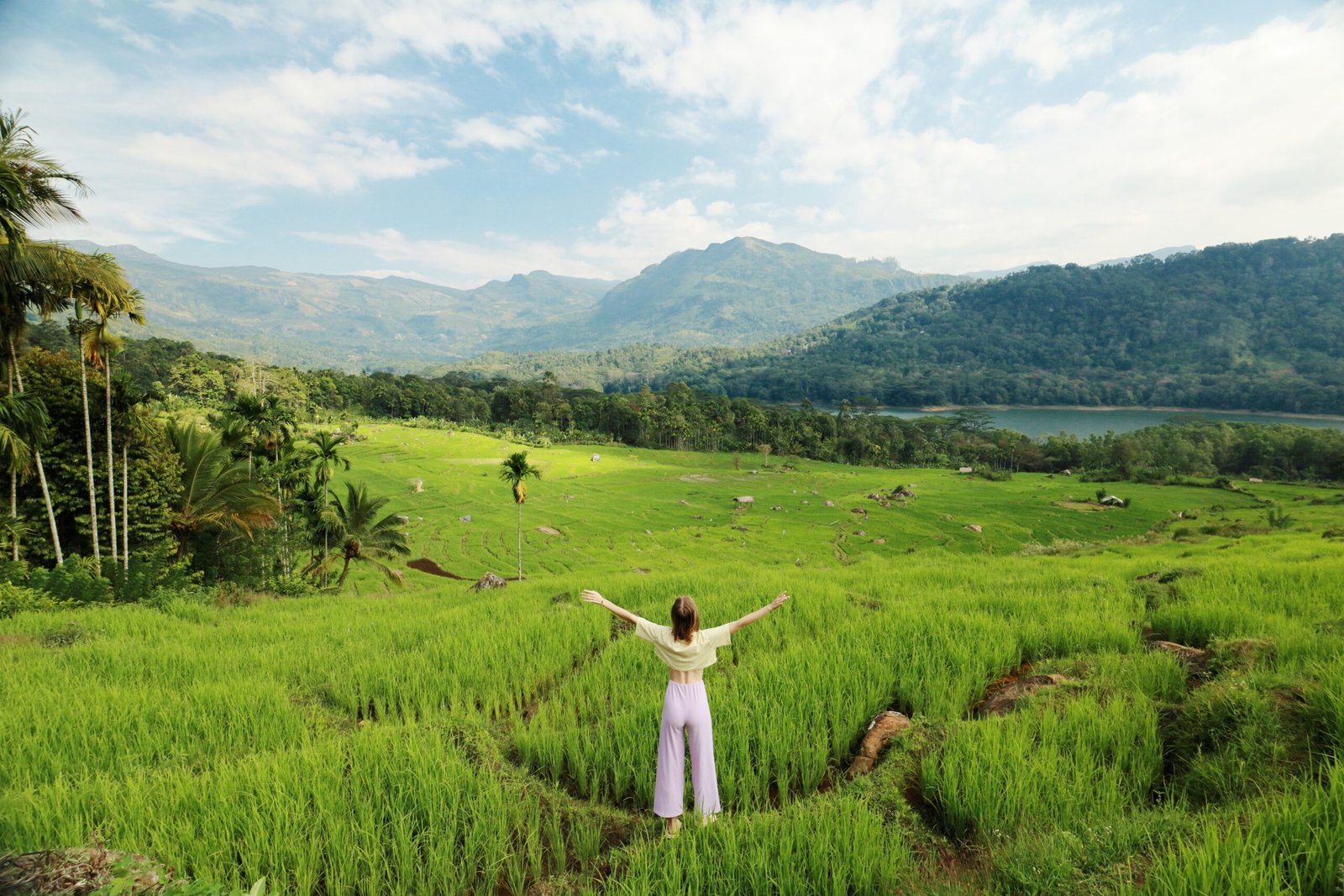 Services traveling women enjoying the view of the green valley full of rice terraces, river and mountains in kotmale, sri lanka